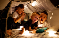 Boys playing in homemade tent with lots of lights