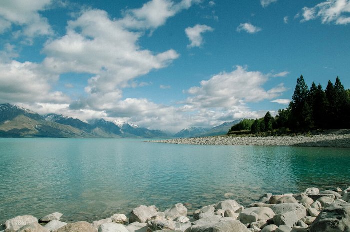 wide lake with mountains in the back