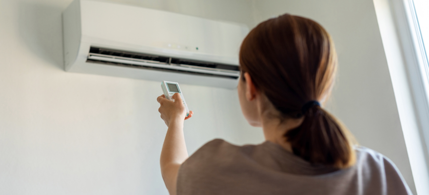 Woman turning on heat pump